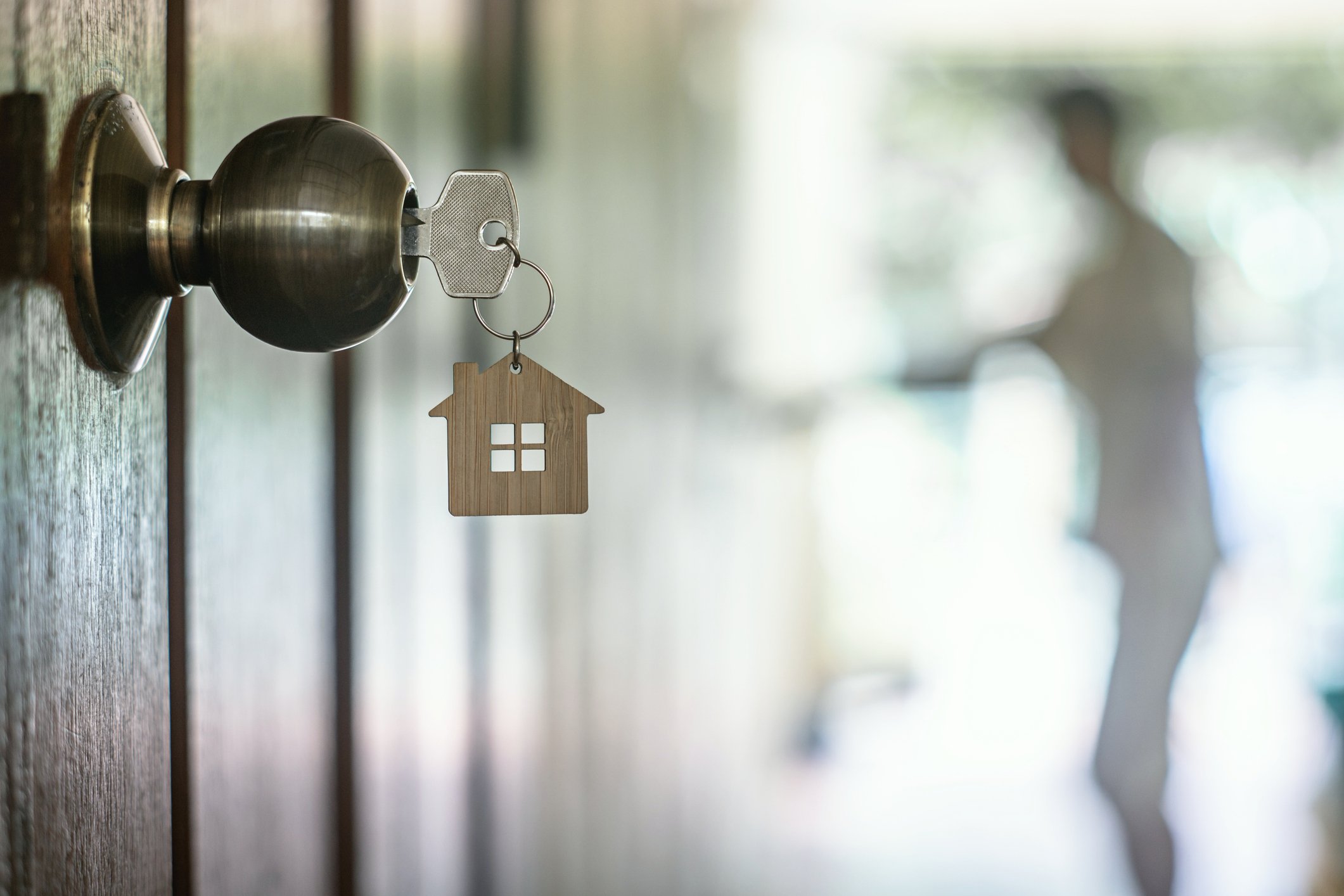 A house key in the front door of a house on move-in day.