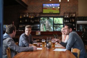 Friends having beers and pizza at one of the sports bars in Rockville Maryland.