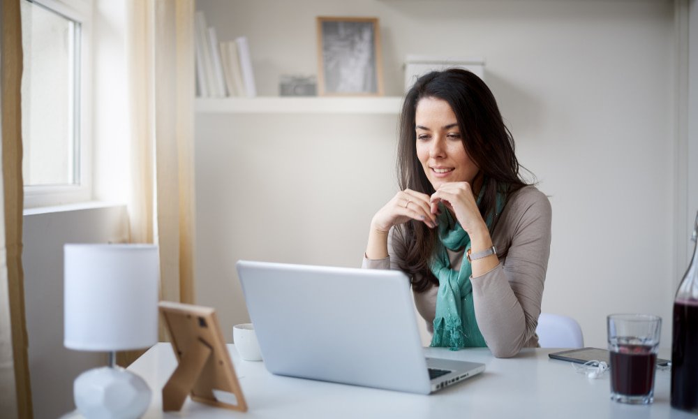 Taxes on Rental Income: Key Things to Know 2 Woman doing her taxes on the computer
