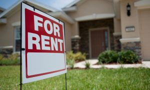 a fir rent sign in front of a rental house