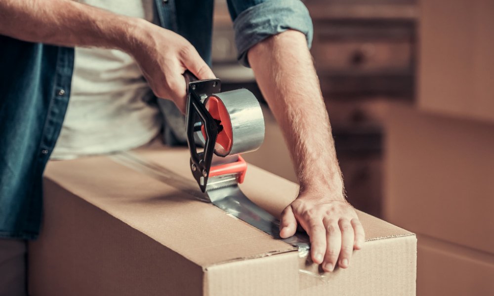 Person packing a box Moving to D.C.