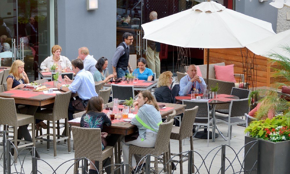 People dining on the patio of a downtown Washington, D.C., restaurant on a nice day.