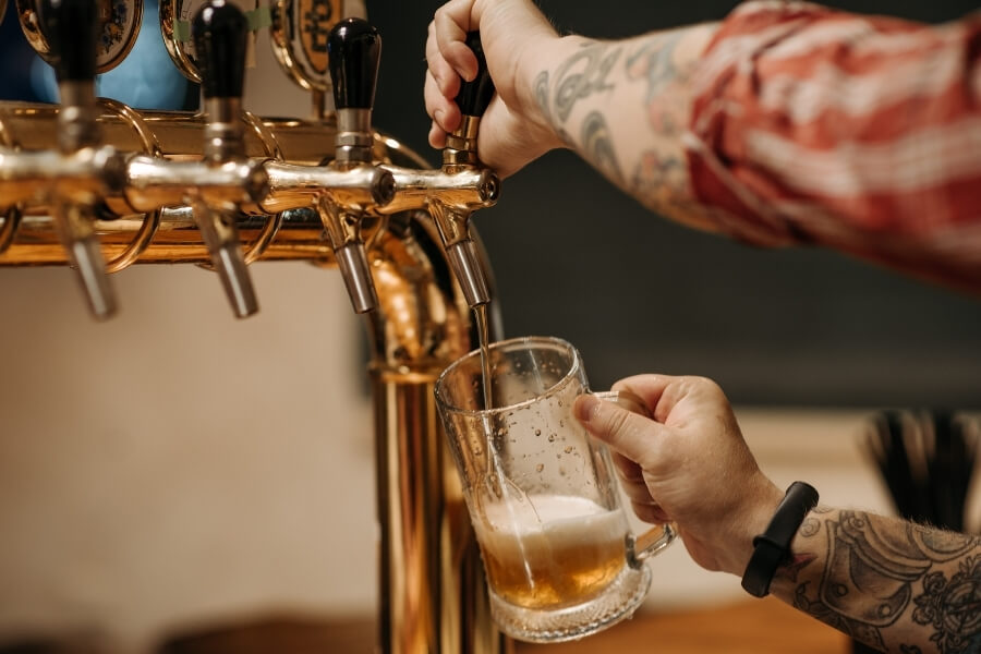 8 Bars You Have to Visit in Hyattsville, MD 1 guy pouring beer from a tap