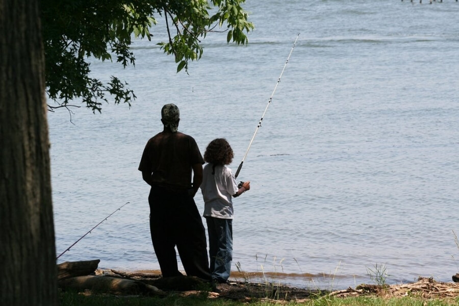 Father and son fishing together while camping at Pohick Bay Regional Park