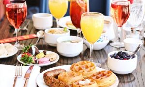 Brunch table with waffles, berries, sparkling mimosas, and other dishes you might find at brunch in McLean, VA