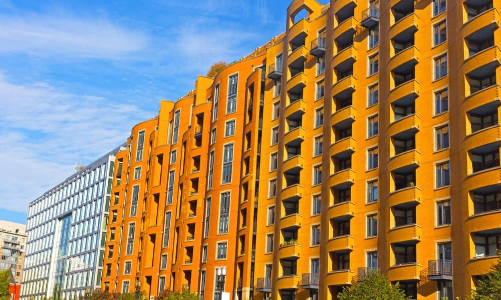 Large orange apartment building in D.C., which requires landlords to learn some apartment essentials before renting