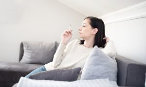 Person smoking in a unit where the landlord will have to learn how to prove a tenant is smoking in an apartment