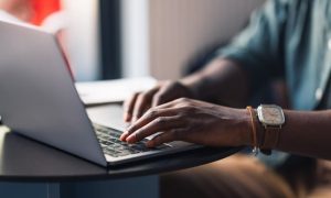 A landlord typing a proof of residency letter