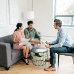 Rental property manager discussing terms with home buyers inside a currently available unit in Washington DC.