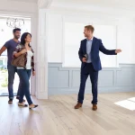Nomadic's real estate agent showing a young couple an available property for rent in Washington DC.