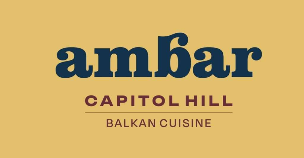 Logo of Ambar, a Balkan cuisine restaurant on Capitol Hill, featuring bold navy blue "ambar" text with a unique stylized "b" and maroon text reading "CAPITOL HILL" and "BALKAN CUISINE" on a golden-yellow background.