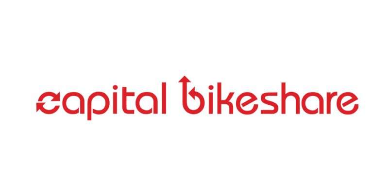 The red Capital Bikeshare logo features the company name in a modern, rounded font with a circular arrow integrated into the “C” and an upward arrow incorporated into the “b,” symbolizing cycling and forward movement.