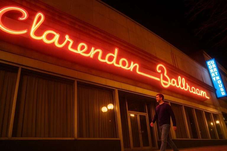 Man walking past Clarendon Ballroom's neon sign at night.