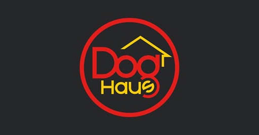 Dog Haus" logo with red text, yellow accents, and a stylized roof graphic on a black background encircled in red.
