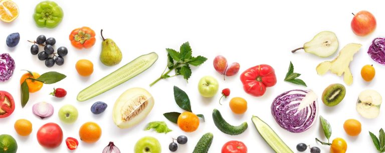 A colorful assortment of fresh fruits and vegetables, including cucumbers, tomatoes, citrus, pears, berries, and cabbage, arranged along the bottom edge of a white background.