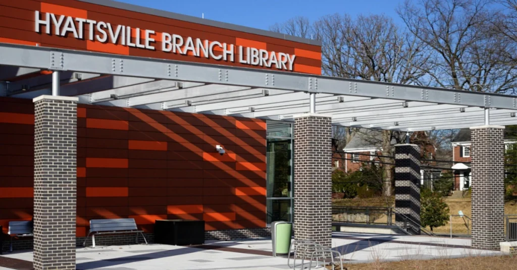 Exterior view of the Hyattsville Library with its modern architecture and a clear blue sky in the background.