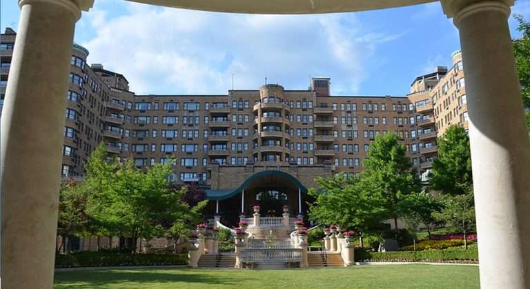 Exterior view of the historic Omni Shoreham Hotel in Woodley Park, Washington, D.C., framed by white columns and surrounded by manicured gardens.