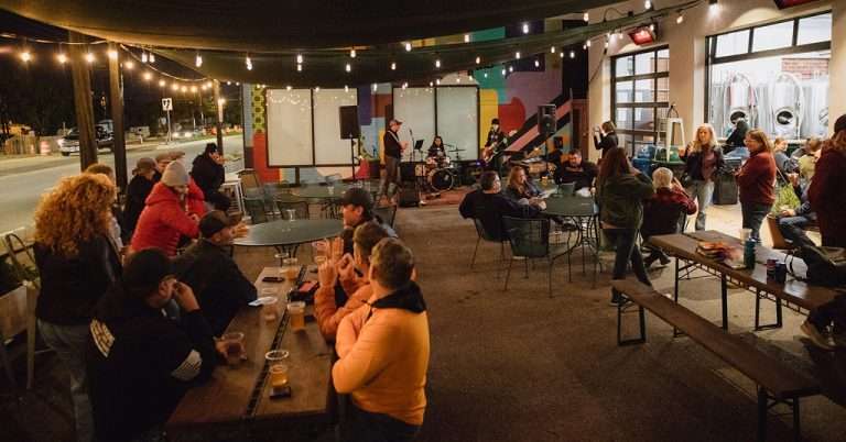 Outdoor Concert Night - Live Music Performance with Audience Under String Lights