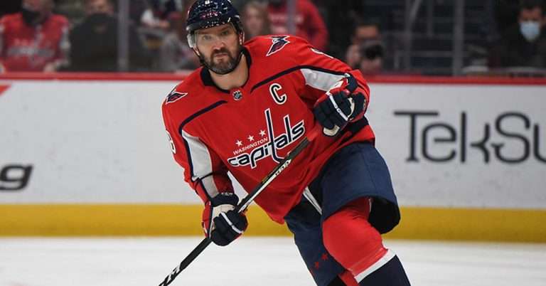 Washington Capitals hockey player in red uniform skating on the ice during a game at Capital One Arena in Washington, D.C.