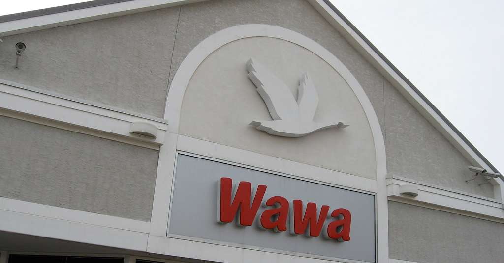 Exterior of a Wawa convenience store featuring the red Wawa logo and a white goose emblem mounted above the entrance.