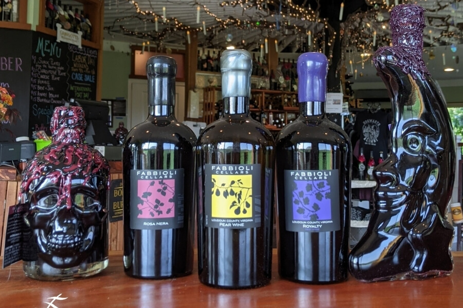three bottles of wine lined up inside the Fabbioli Cellars