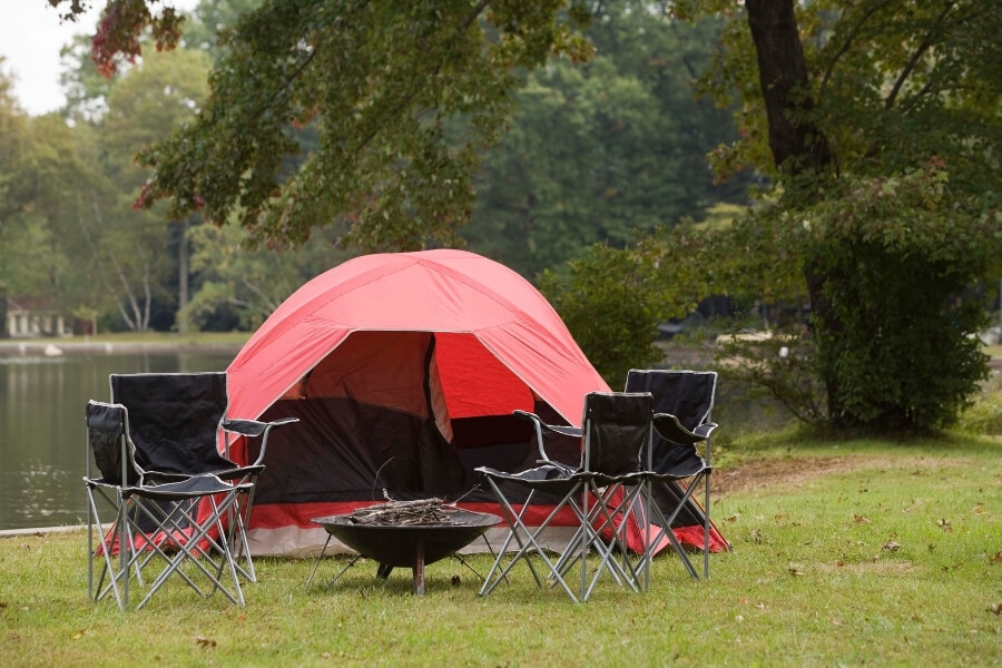 Tent with chairs and fireplace in a campground at Oak Ridge