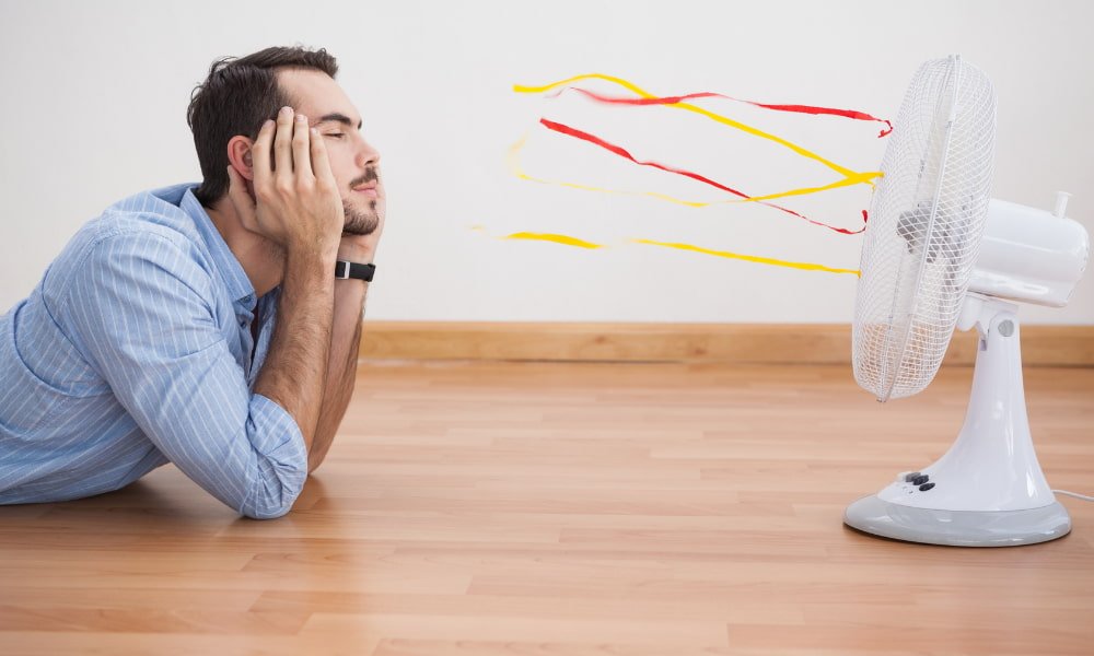 Top 6 Tips to Beat the Summer Heat 1 Man laying in front of a fan