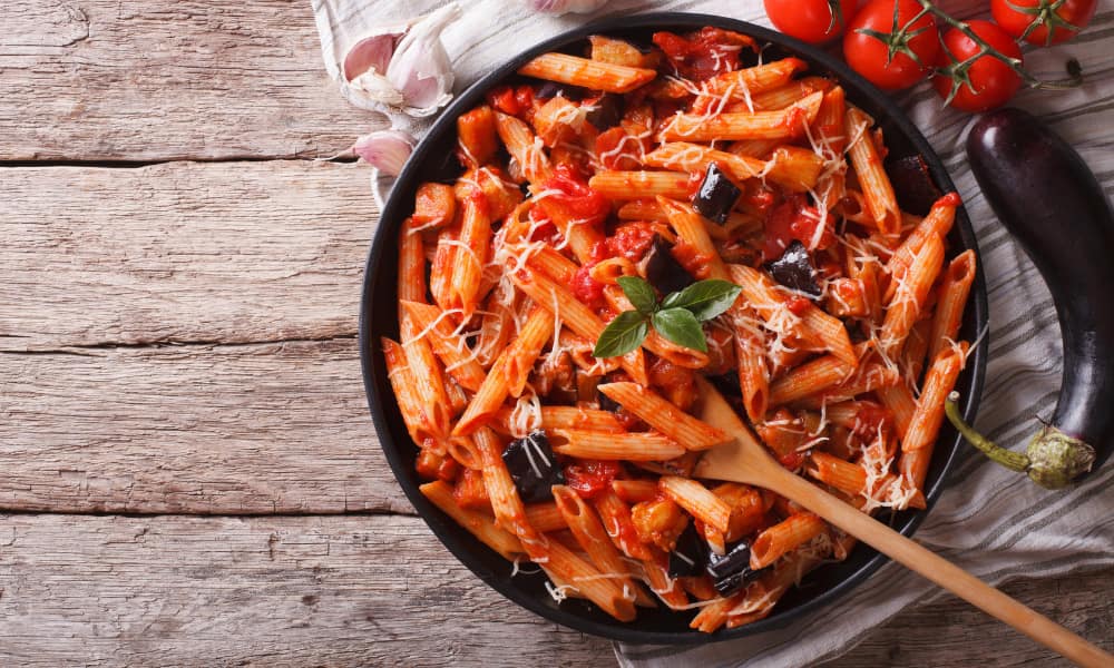 a bowl of italian penne pasta and tomato sauce