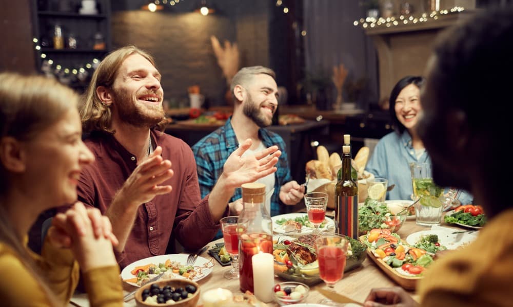 Friends and family enjoying a meal around a table at one of the best restaurants in Alexandria, VA.