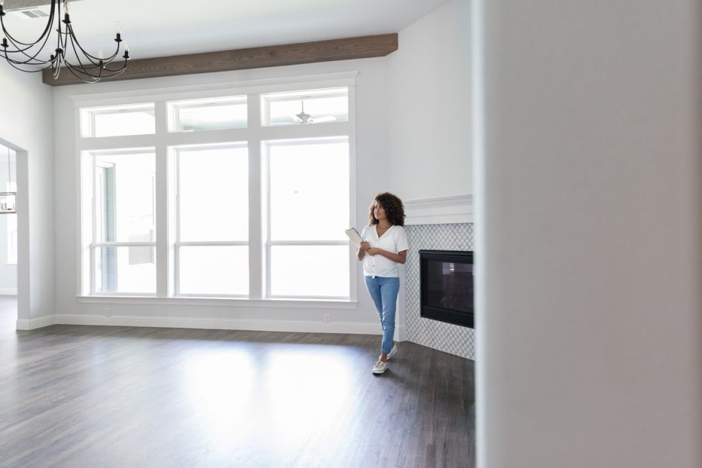 Woman in an empty apartment conducting move-out inspection